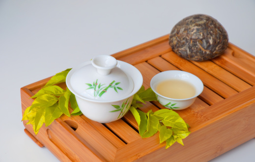 Chinese tea in teapot with cup isolated