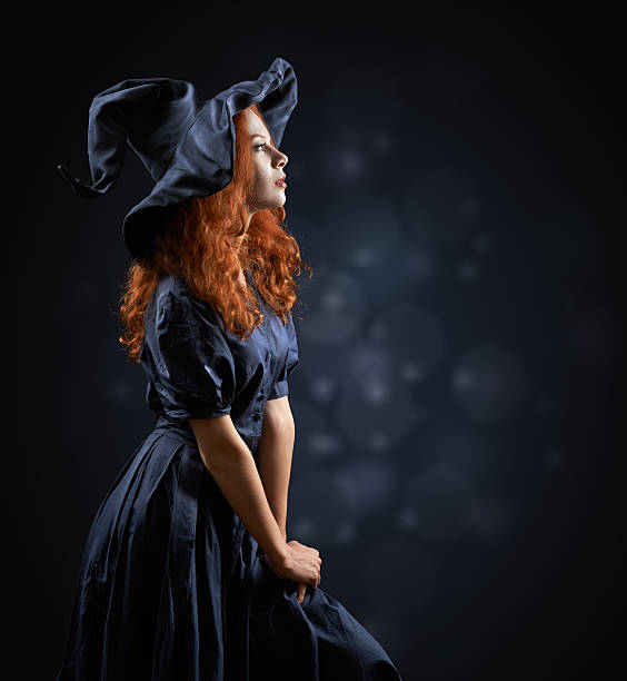 istock beautiful red-haired girl in a  costume witch 511789049