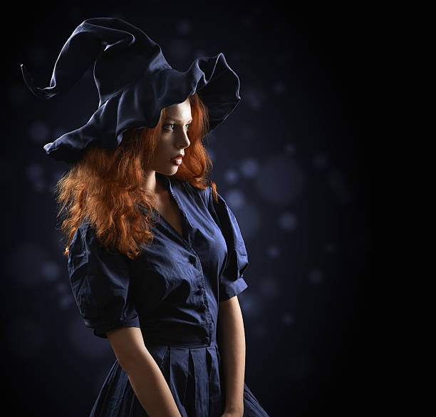 istock beautiful red-haired girl in a  costume witch 511789061