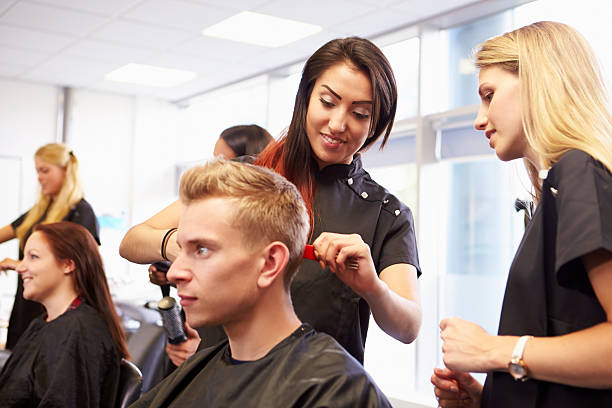 istock Teacher Helping Students Training To Become Hairdressers 511789103
