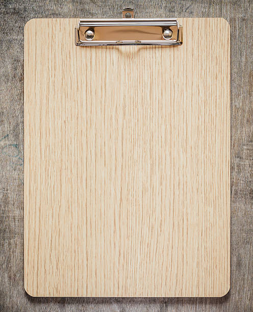 Clipboard On Wooden Table Stock Photo - Download Image Now