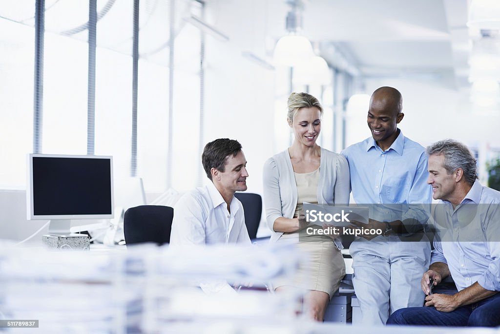 Idea sharing Shot of a group of businesspeople discussing paperwork in office Meeting Stock Photo