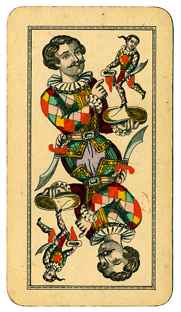Tarot Fool or Joker Austrian Taroch playing card 1900 This is the Fool (Joker), an un-numbered picture card from a pack of large Tarot cards (called Taroch or Tarok in German). Cards in this pack measure 74 x 129mm. The maker is  Fred. Piatnik & Sohne of Vienna. The Fool is a Harlequin holding a hat, and on the hat is a representation of himself. This design is in some ways similar to the Trump card number I (one), where Harlequin is shown holding a harp, and on the harp is a smaller version of himself. The history of Tarot goes back to 15th century Italy. There were 78 cards, including 21 'trump' cards and a 'fool' or 'skeench' dressed as a harlequin, which in modern packs would be called a joker. The large numbers of cards and the complicated rules led to a decline in the popularity of these Tarot card games. Austrian Taroch cards use French symbols (clubs, diamonds, hearts and spades), and a simplified pack numbering 54, which still includes the 21 trumps plus the fool. These make up the 22 'Taroch' (trump) cards. This particular pack was made by Piatnik (Vienna) in 1900. fool stock pictures, royalty-free photos & images
