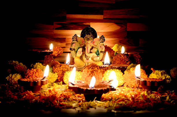 istock Clay diya lamps lit with Lord Ganesha during diwali celebration 511791056
