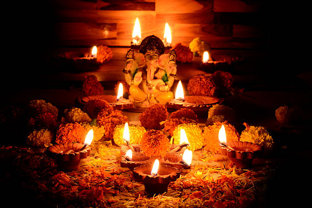 istock Clay diya lamps lit with Lord Ganesha during diwali celebration 511791068