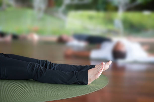 istock People laying in yoga mats 511791475
