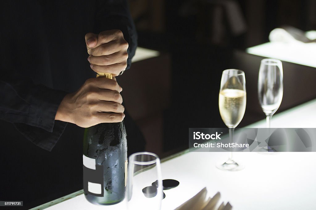 Bartender opening champagne bottle Opening Stock Photo