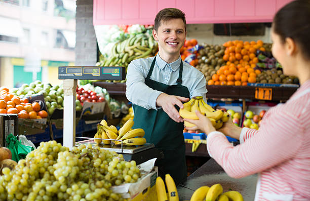 istock seller weighing bananas 511793002