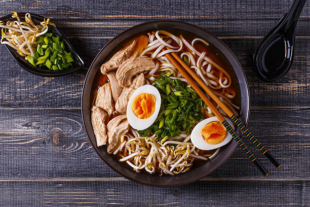 Japanese ramen soup with chicken, egg, chives and sprout. Japanese ramen soup with chicken, egg, chives and sprout on dark wooden background. noodle soup photos stock pictures, royalty-free photos & images