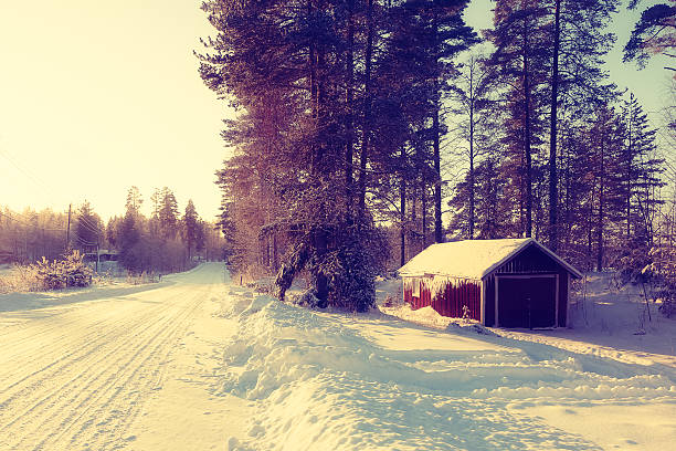 istock Winter landscape with forest road and sunlight 511793166