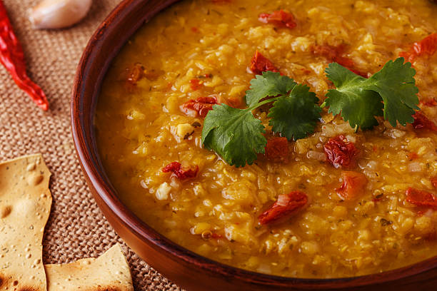 istock Thick indian red lentil soup served with indian flat bread. 511793360