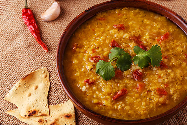 istock Thick indian red lentil soup served with indian flat bread. 511793594