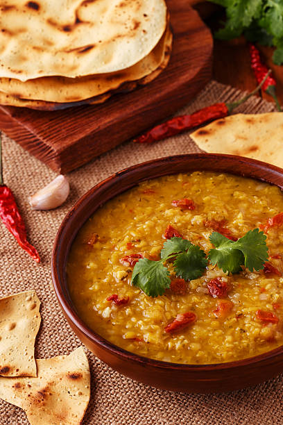 istock Thick indian red lentil soup served with indian flat bread. 511793690