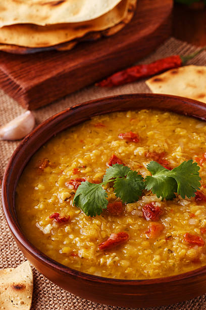 istock Thick indian red lentil soup served with indian flat bread. 511793770
