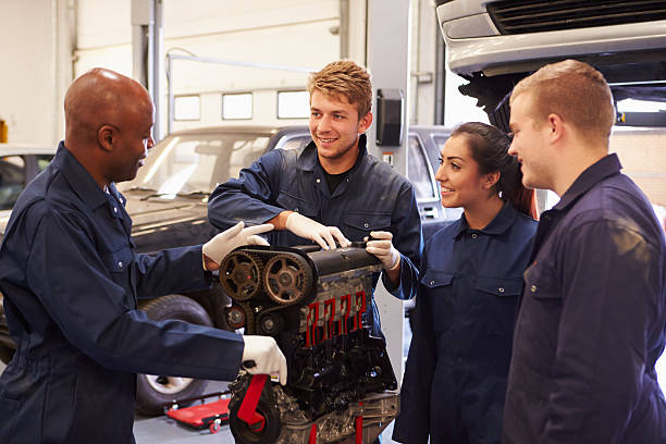 istock Teacher Helping Students Training To Be Car Mechanics 511793801