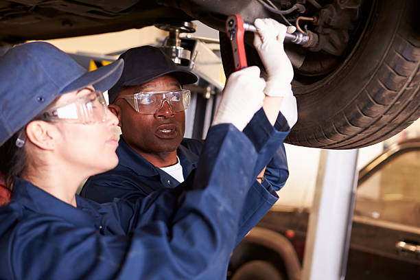 istock Teacher Helping Student Training To Be Car Mechanics 511793851