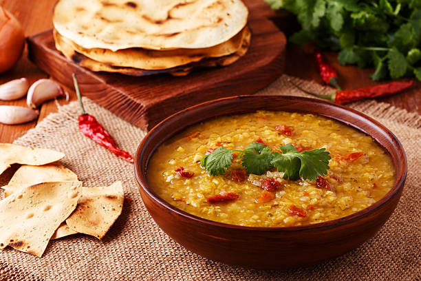 istock Thick indian red lentil soup served with indian flat bread. 511793960