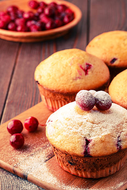 istock Cranberry muffins on wooden background. 511794160