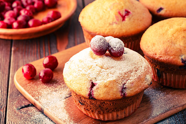istock Cranberry muffins on wooden background. 511794236