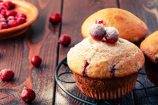 istock Cranberry muffins on wooden background. 511794590