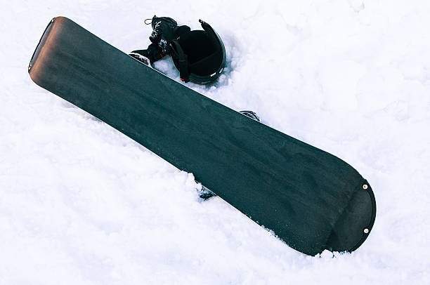 istock Board for snowboarding and helmet in the snow 511794664