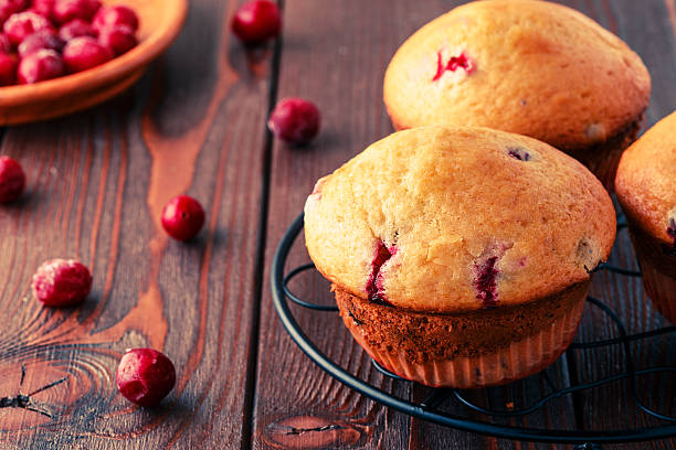 istock Cranberry muffins on wooden background. 511794666