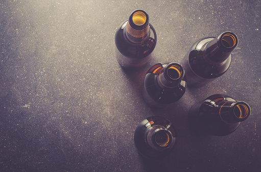 Beer bottles on dark table. Close up