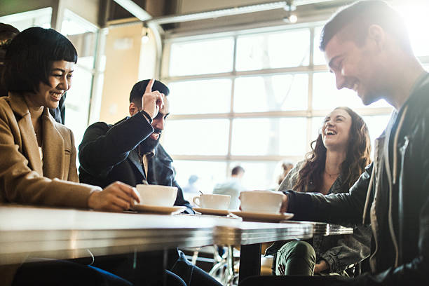 Friends Laughing in Coffee Shop