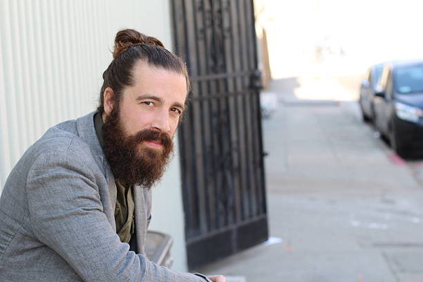 istock bearded hipster model with man bun hairstyle 511797750