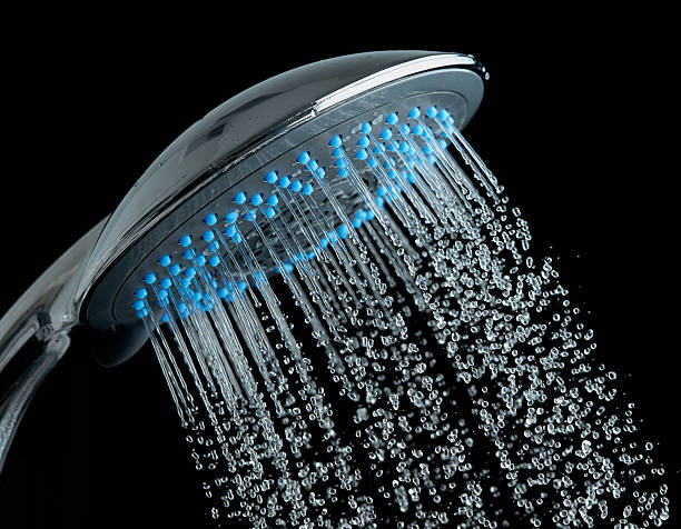 istock Shower with running water over black background 511799616
