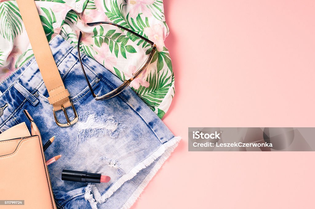 Overhead shot of female casual clothes Overhead shot of female casual clothes on pink background Summer Stock Photo