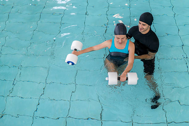 istock Woman doing physical therapy in the swimming pool 511803058