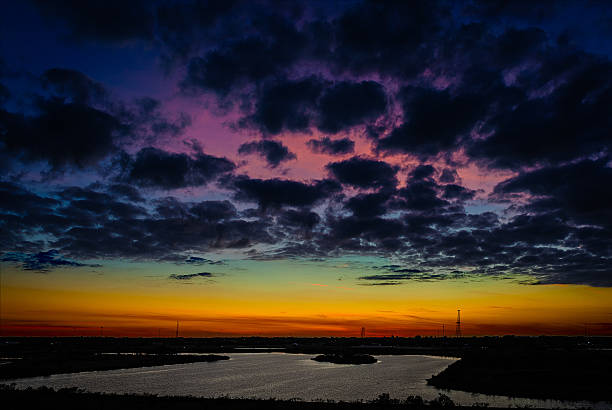 istock Blue Clouds rise above a rainbow of sunset colors 511803114