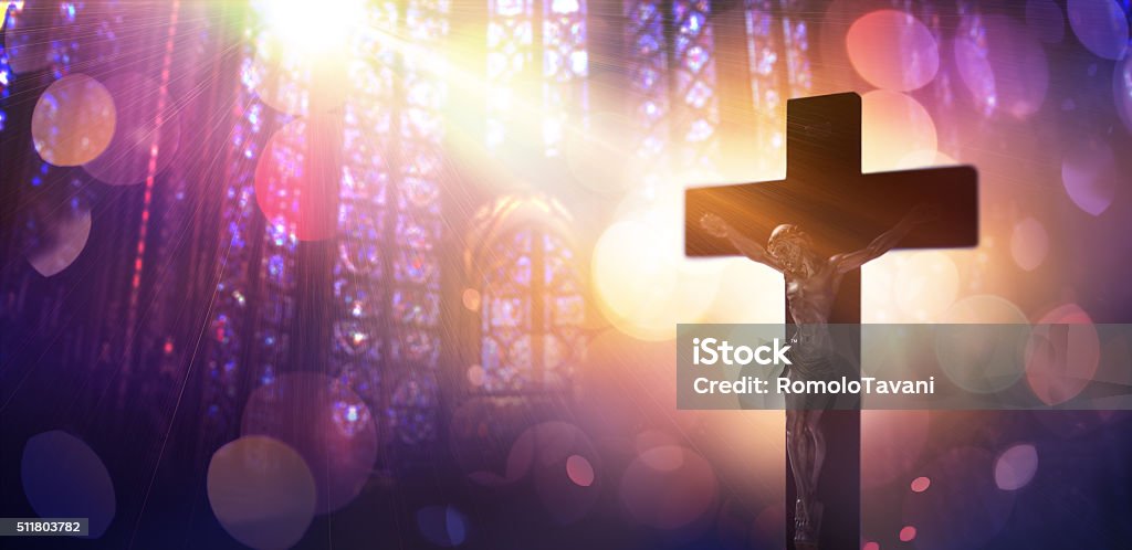 Crucified Christ - Symbol Of Catholic Faith crucifix illuminated of the light of god Catholicism Stock Photo