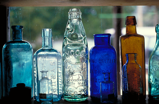 Line of Large Variety of Blue Glass Bottles Different Sizes