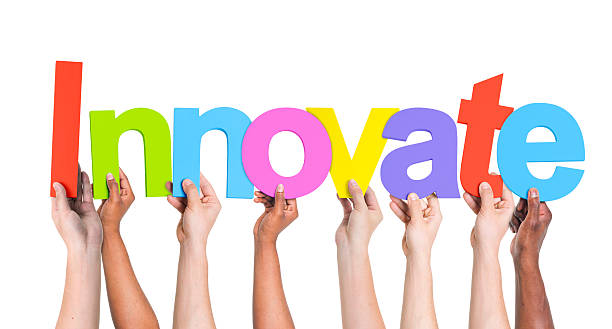 istock Multiethnic Group of People Holding Word Innovate 511804935