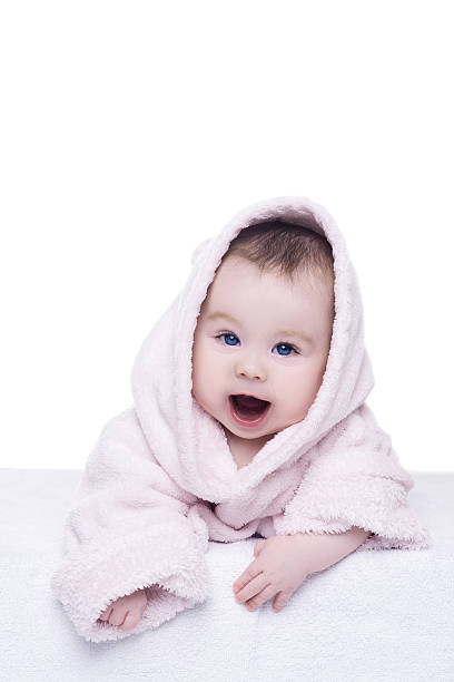 istock baby girl in pink bathrobe lying on her belly 511805168
