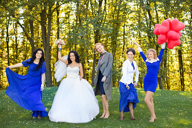 istock Bride with her friends dancing in the meadow 511805616