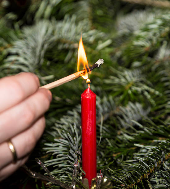 istock Lightning the candles at the christmas tree 511806276