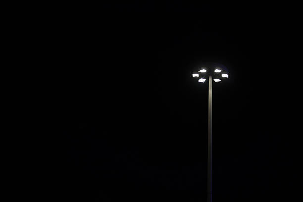 istock lamppost in the pitch-black night 511806528