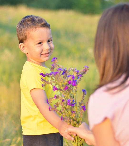 Son is Giving his Mother Flowers
