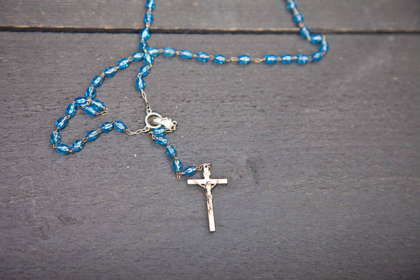 istock Rosary on dark black wooden background 511807120