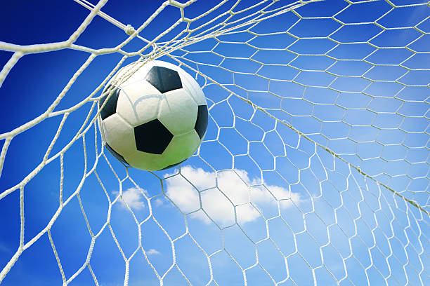 istock soccer ball in goal with blue sky 511807539