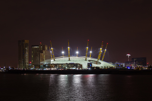 London, UK - July 16, 2015: The Millenium Dome in London from across the River Thames. New apartments can be seen at the side.