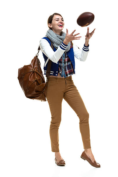 istock Happy female student playing with football 511808177