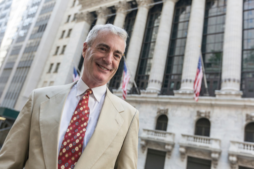 Senior Businessman in front of Wall Street Stock Exchange