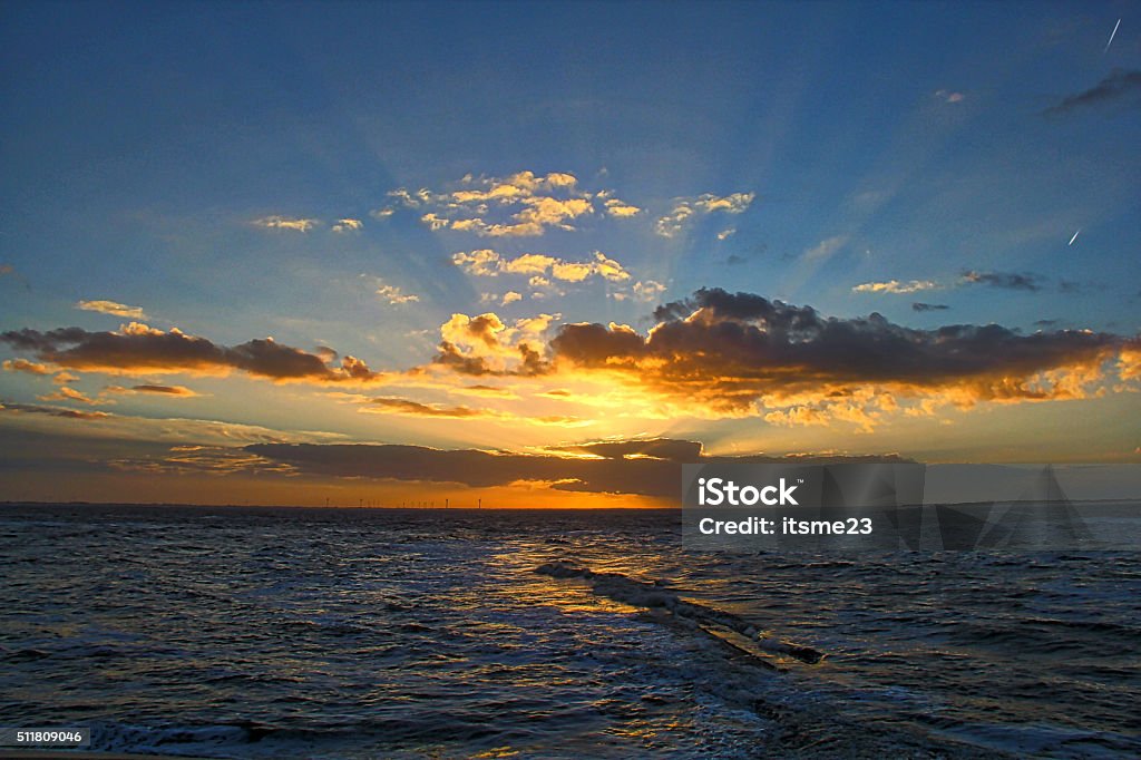 Sunset at the sea The sunset with rays of light in the west part of the isle of Wangerooge, Germany in the Northsea. Wangerooge Stock Photo