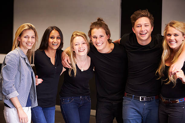 Portrait Of Students With Teacher At Drama College Portrait Of Students With Teacher At Drama College Smiling To Camera theater class stock pictures, royalty-free photos & images