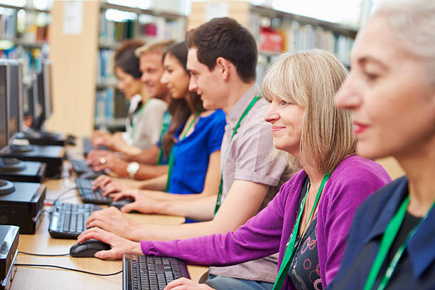 istock Group Of Mature Students Working At Computers 511810435