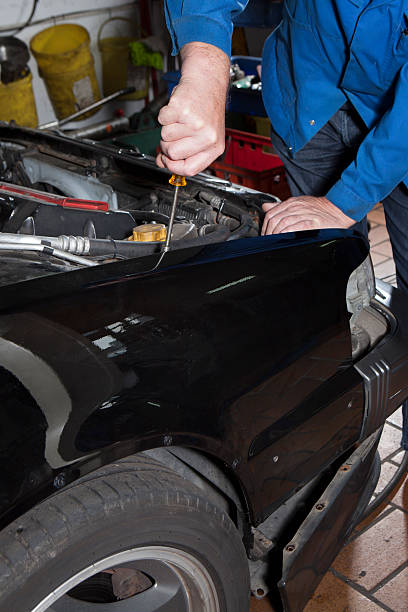 istock Auto repair shop - mounting a fender 511810641